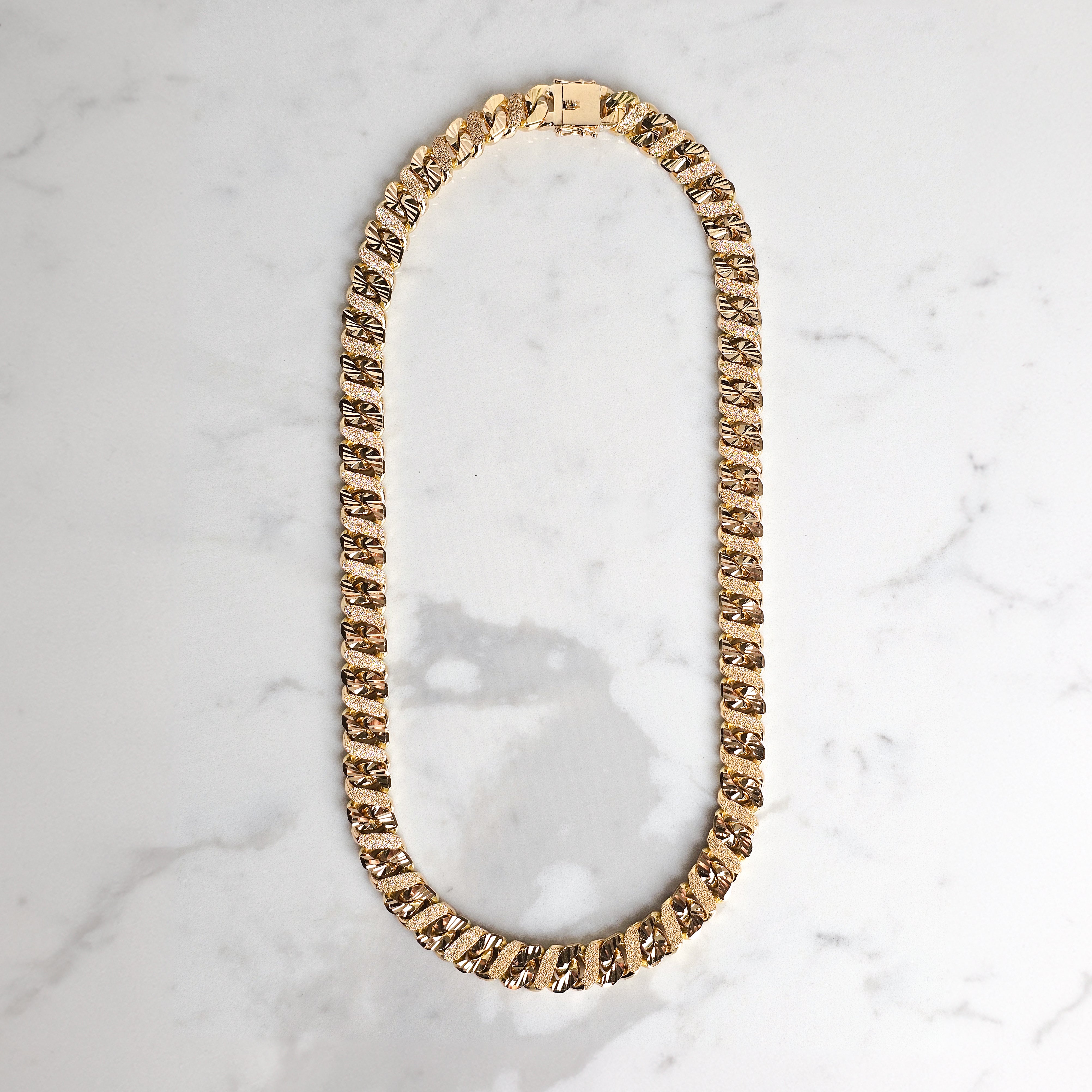 heavy gold mens chain on marble background