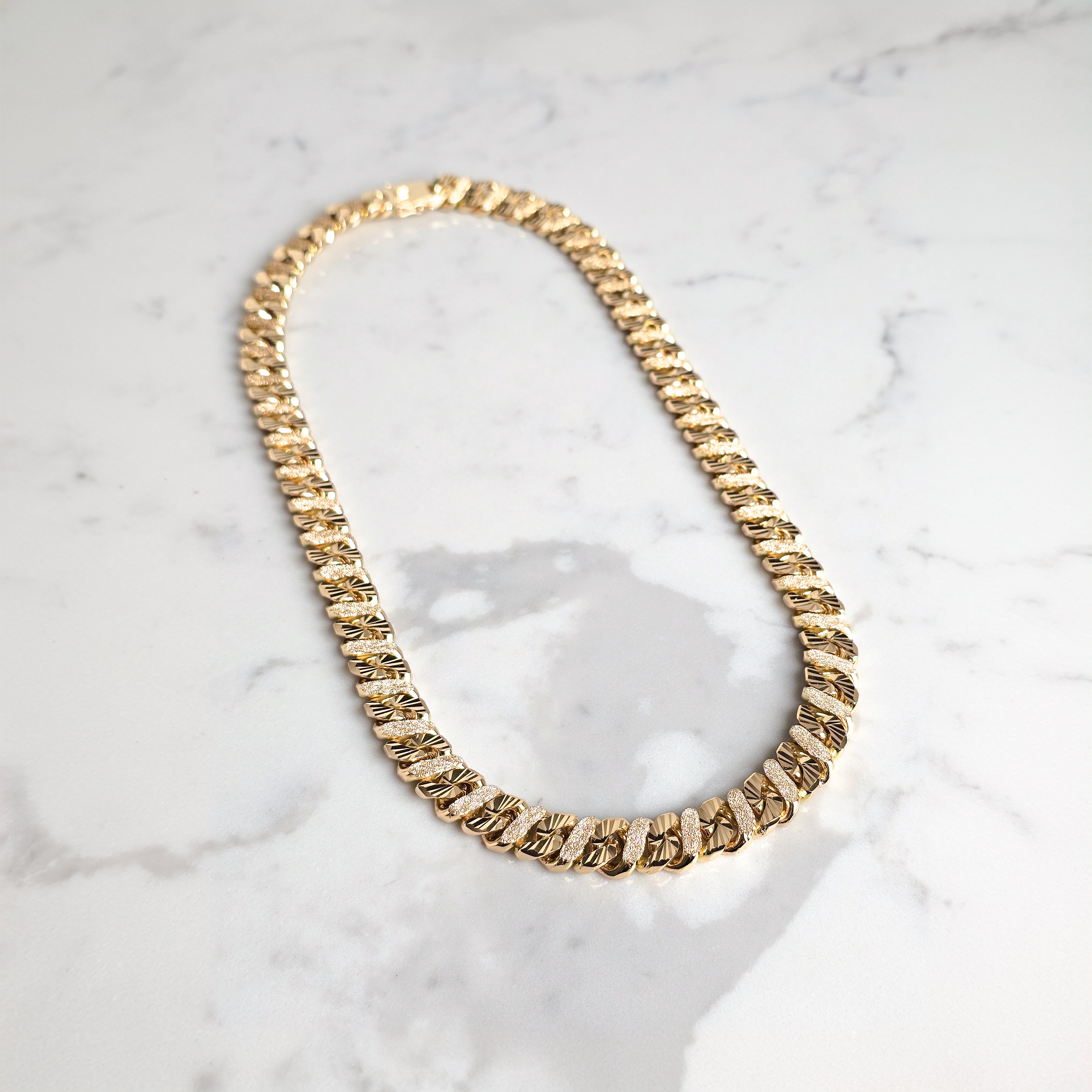diamond gut solid gold chain mens jewellery on marble background