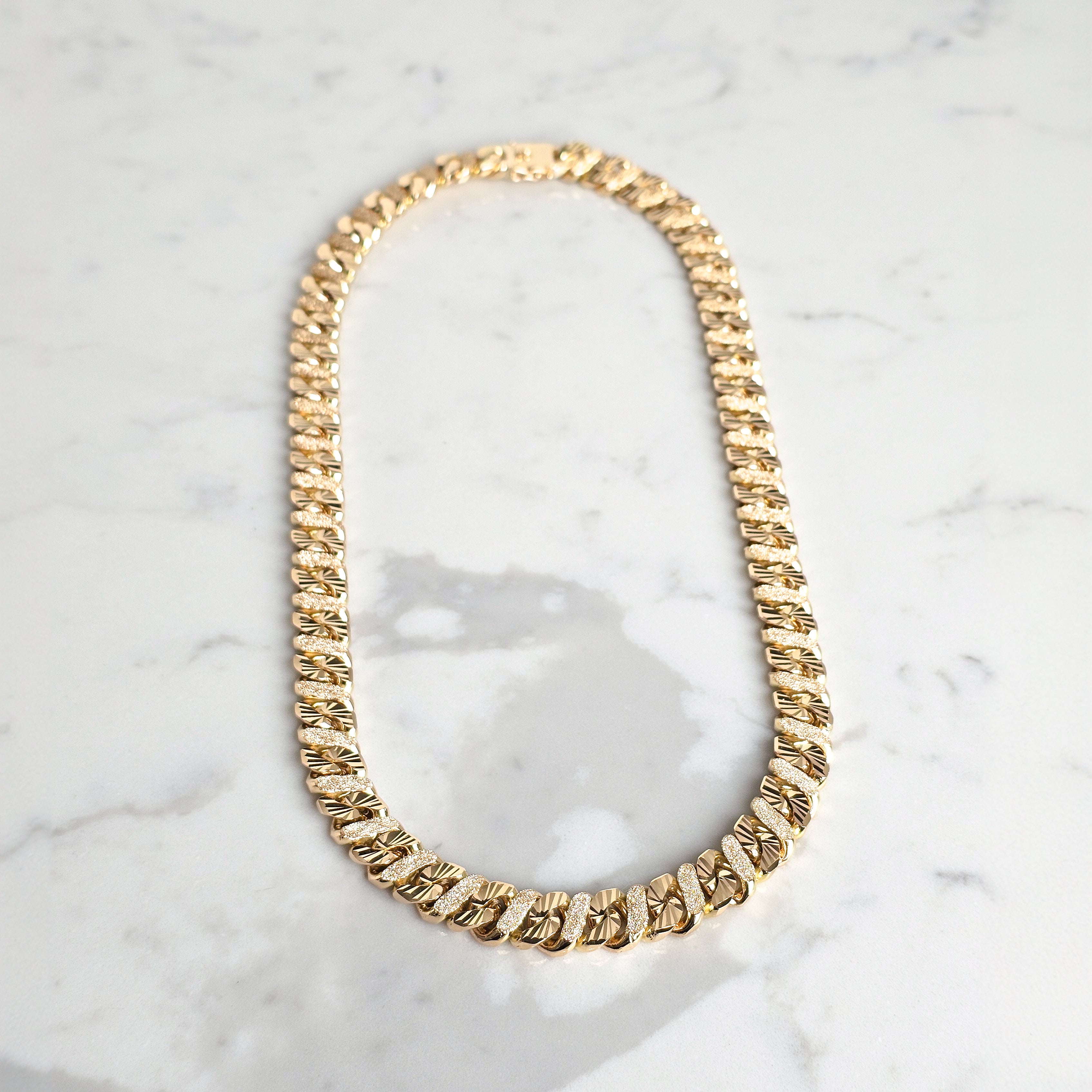 gold mens chain on marble background