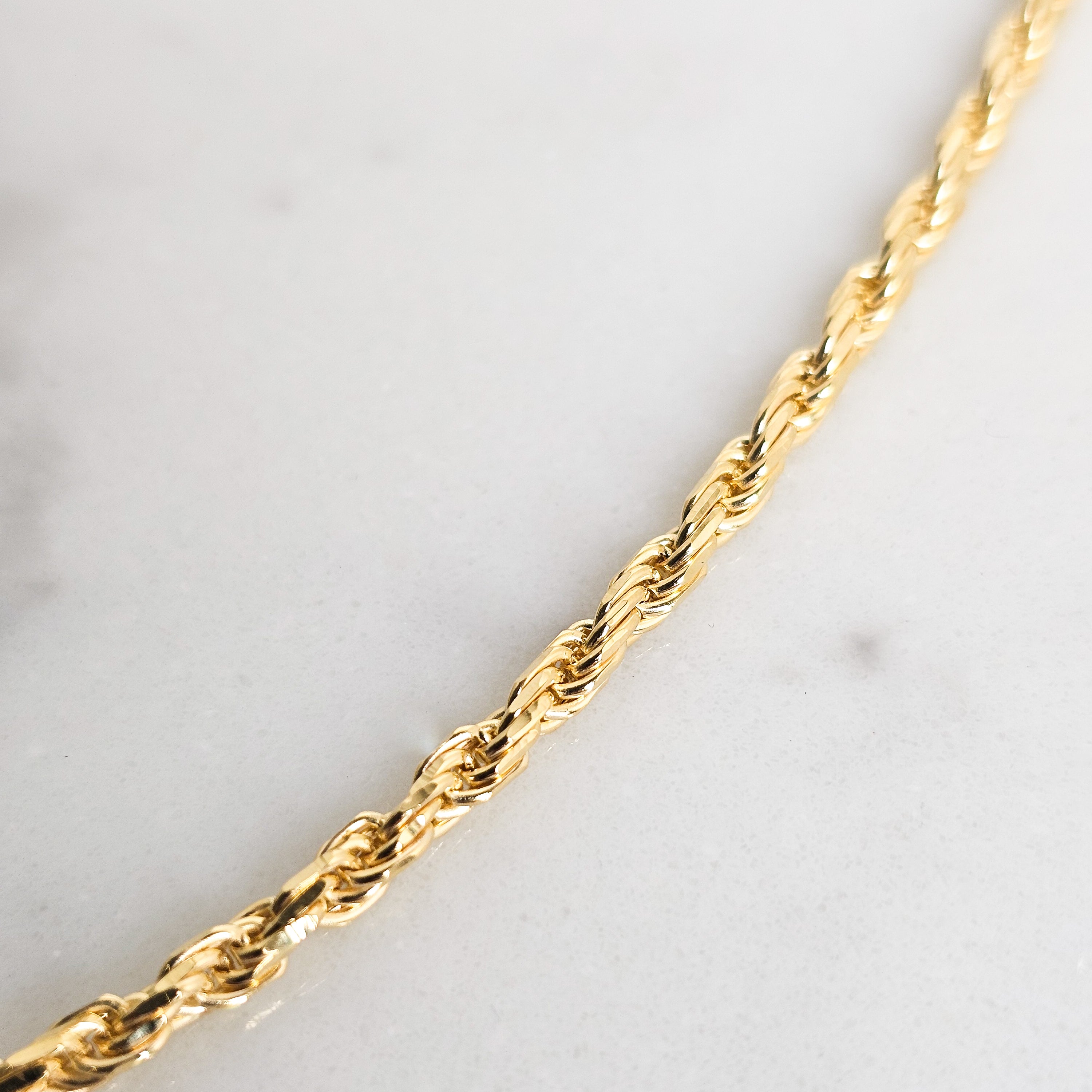 close up of yellow gold rope chain diamond cut