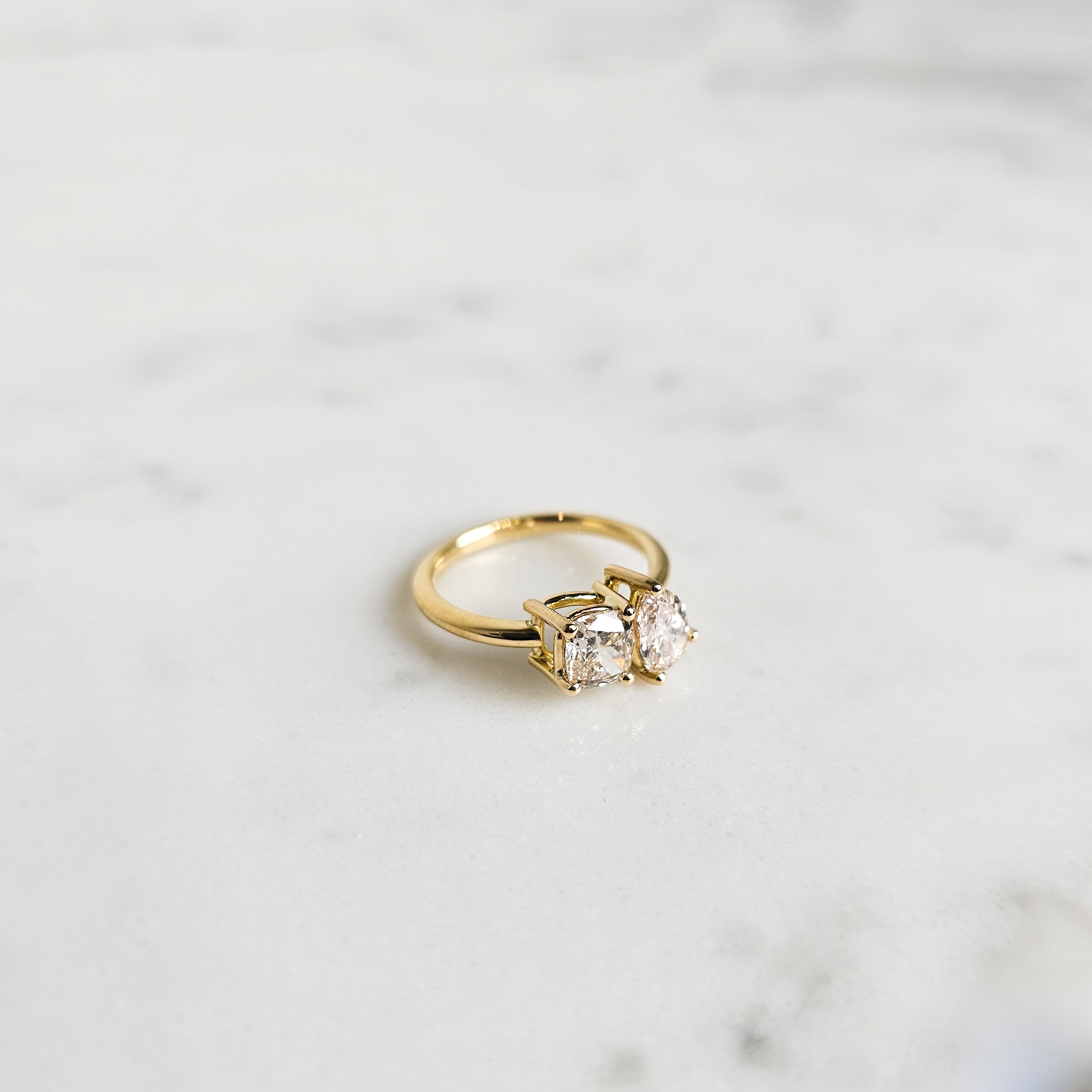 Toi Et Moi Engagement ring in 18ct yellow gold featuring a cushion cut and fancy rear shape diamond