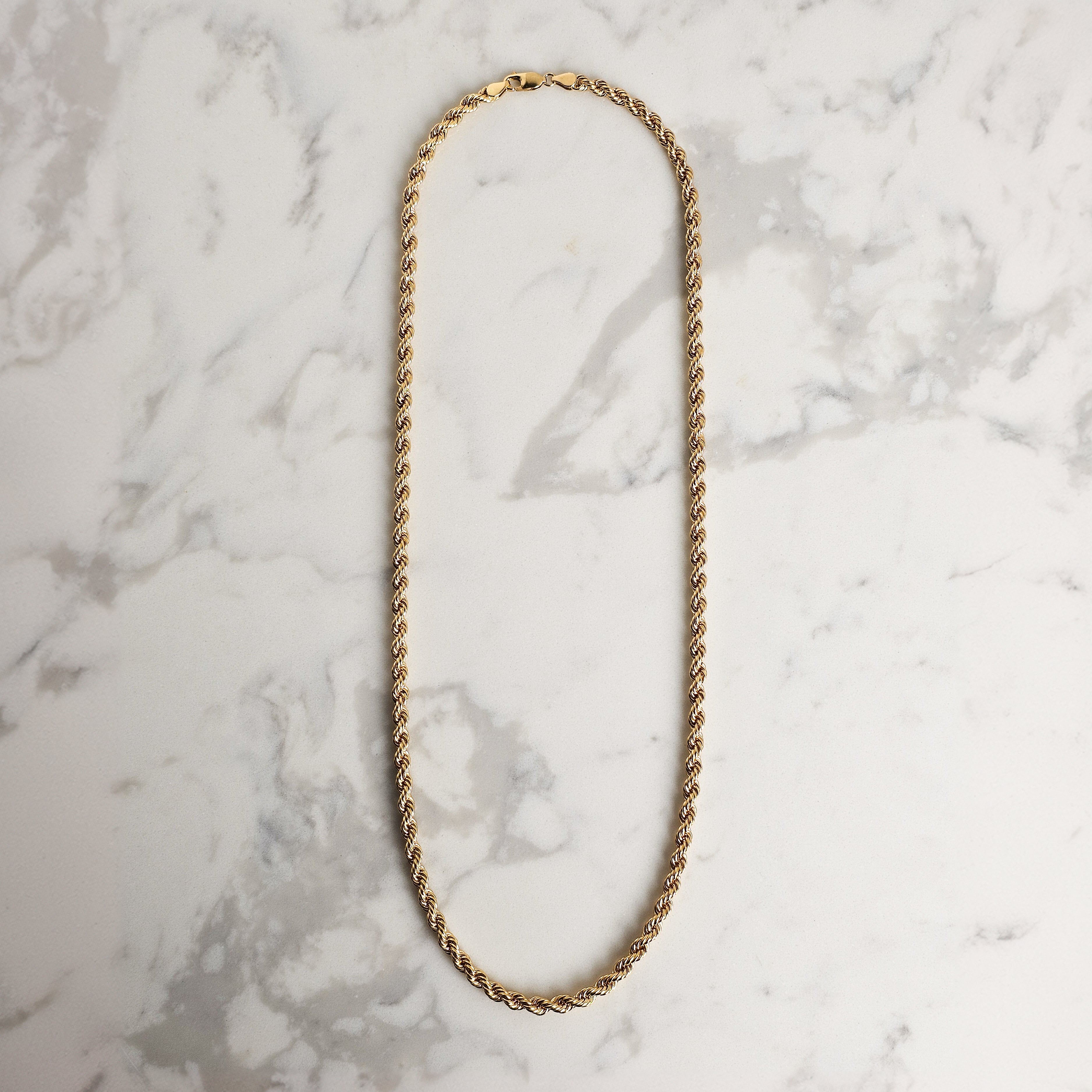 mens rope chain yellow gold marble background 